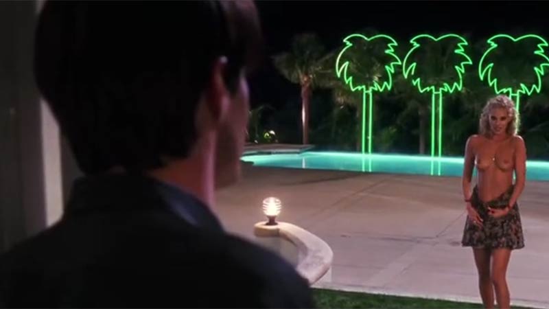 Sultry whirling dervish of a blonde seduces a man in a public pool