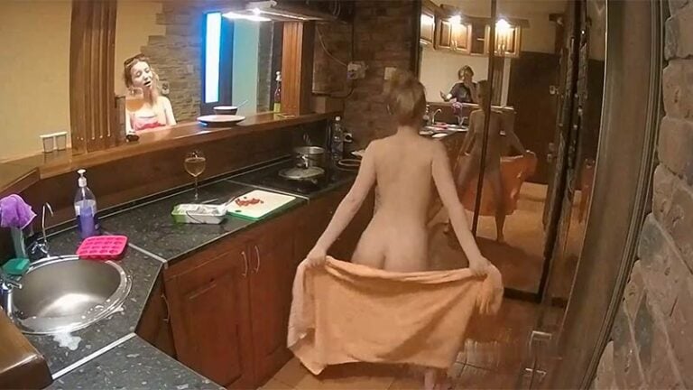 Happy naked dancing girl in the kitchen
