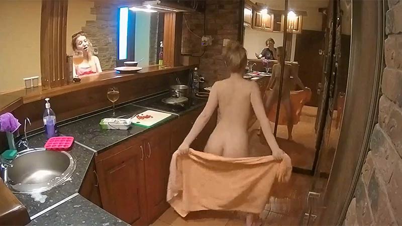 Happy naked dancing girl in the kitchen