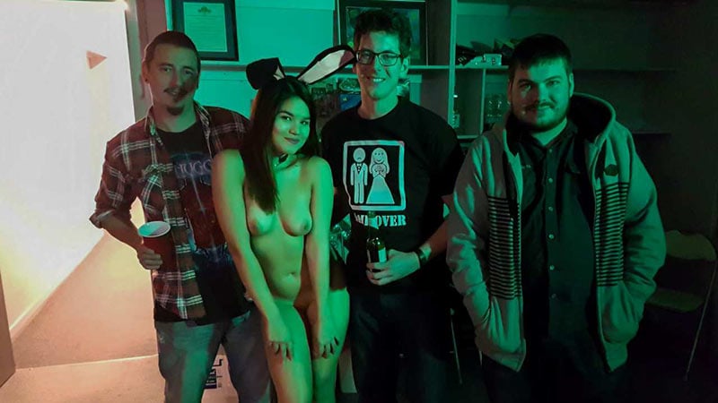 Asian girl hangs out and parties naked with a group of men